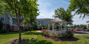 Woodbridge apartment for rent - a white gazebo in the middle of a yard with flowers at River Run, Woodbridge, VA  