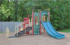Mooresville apartment for rent - A playground with a green slide, red and yellow climbing frame, and a black ramp.