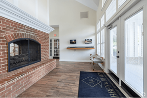 South Riding apartment for rent - A brick fireplace is in a room with a blue rug on the floor.