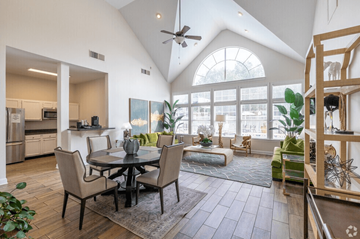South Riding apartment for rent - A modern open plan living and dining room with a kitchen in the background.