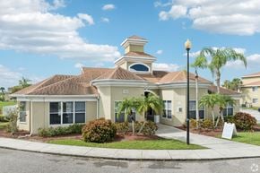 Ellenton apartment for rent - A house with a brown roof and a white sign in front.