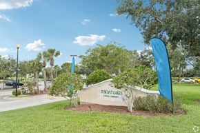 Ellenton apartment for rent - A sign that says Tuscany Lakes is in front of a grassy area.