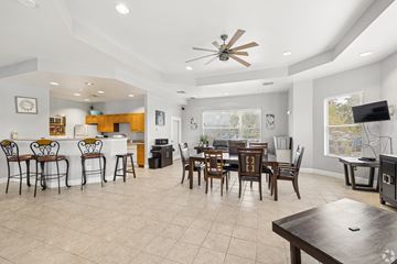 Ellenton apartment for rent - A spacious kitchen and dining area with a ceiling fan and a television.