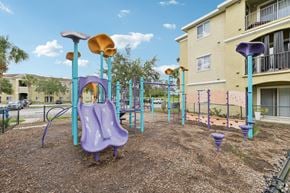 Ellenton apartment for rent - A playground with a purple slide and a yellow slide.