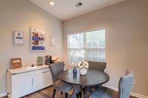 Fredericksburg townhouse for rent - A dining room with a table set for two and a window with blinds.at The Village at England Run, Fredericksburg, VA 22406