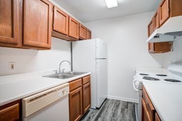 Rock Hill apartment for rent - A kitchen with white appliances and wooden cabinets.