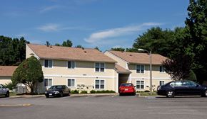 Richmond apartment for rent - a parking lot with cars in front of a building
