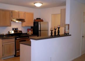 Chester apartment for rent - A kitchen with wooden cabinets and a black stove top oven.