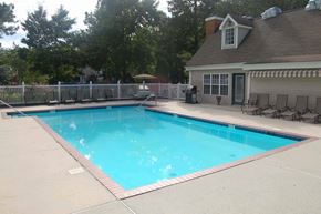 Chester apartment for rent - A small residential pool with a deck and a house in the background.
