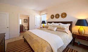 Dumfries apartment for rent - A bedroom with a large bed and a lamp on the side table.