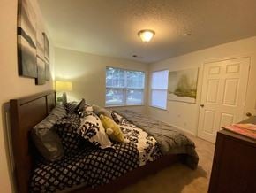 South Riding apartment for rent - A bedroom with a bed, nightstand, and window.