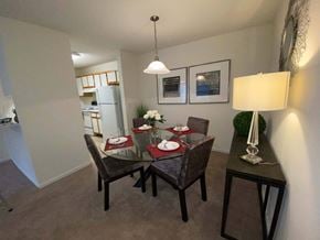 South Riding apartment for rent - A dining room with a table set for two and a framed picture on the wall.