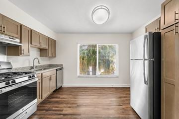 St. Petersburg apartment for rent - A kitchen with wooden cabinets and a white fridge.