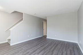Greenville apartment for rent - A room with a wooden floor and a staircase leading to the upper floor.at Jamestown Pointe Apartments, South Carolina, 29607