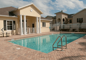 Fort Pierce apartment for rent - A pool in front of a house with a white fence.