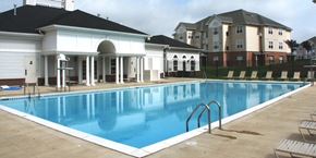 Landover apartment for rent - A large swimming pool in front of a building.