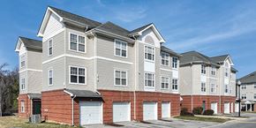 Landover apartment for rent - A large, multi-story residential building with a brick base and white upper floors.