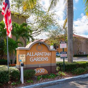 Miami apartment for rent - The Allapata Gardens sign is in front of a building.