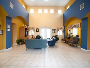 Florida City apartment for rent - A spacious waiting room with a blue and yellow color scheme.