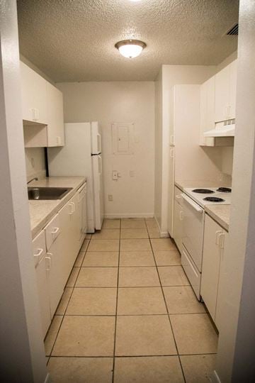 Homestead apartment for rent - A kitchen with white appliances and cabinets.