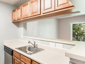 Fort Lauderdale apartment for rent - A kitchen with a white counter top and brown cabinets.