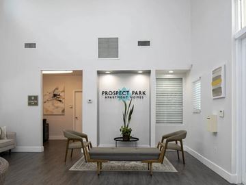 Fort Lauderdale apartment for rent - A living room with a sofa, chairs and a table with a plant on it.