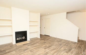 A room with a fireplace and wooden floors
