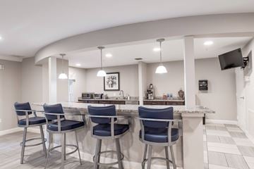 Rockville apartment for rent - A kitchen with a bar area featuring blue chairs and a white counter.