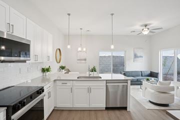 Phoenix townhouse for rent - A modern kitchen with white cabinets and a large island.