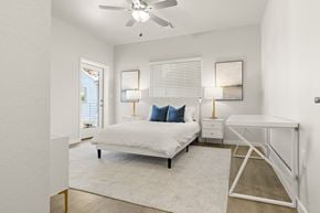 Phoenix townhouse for rent - a bedroom with a bed and a ceiling fan