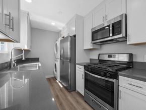Westminster apartment for rent - a kitchen with a stove top oven next to a refrigerator