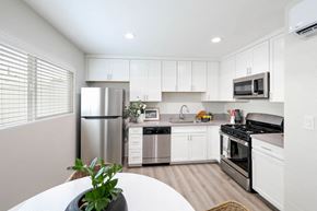 Westminster apartment for rent - a kitchen with white cabinets and stainless steel appliances