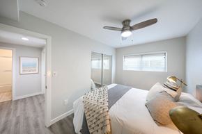 Westminster apartment for rent - a bedroom with a large bed and a ceiling fan
