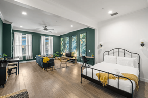Tampa apartment for rent - a bedroom with a bed and a living room with a table and chairs