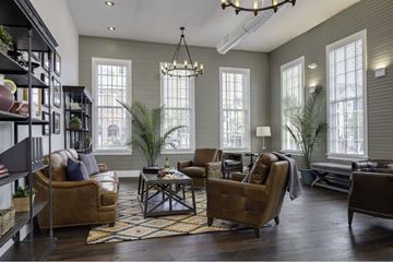 Tampa apartment for rent - a living room with brown leather furniture and a chandelier