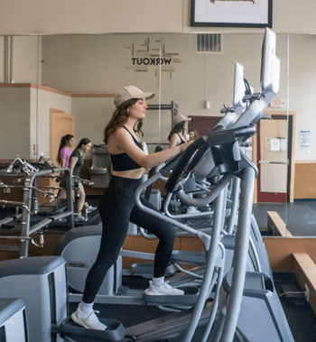 A woman running on a treadmill in a gym