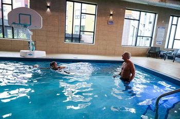 A man and a child in a swimming pool