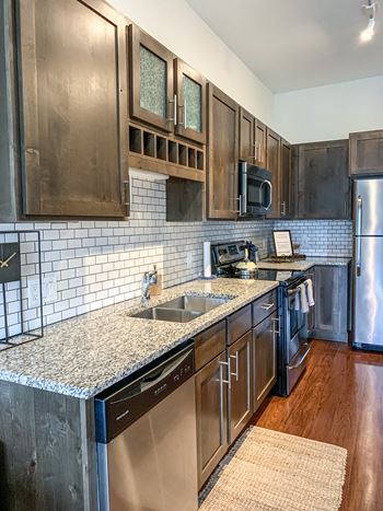 A kitchen with stainless steel appliances and granite counter tops