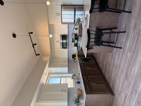 Hugo apartment for rent - A modern kitchen with wooden cabinets and a white countertop.