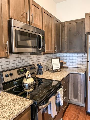 A kitchen with a stove and a microwave