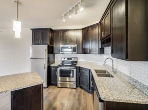 Forest Lake apartment for rent - a kitchen with stainless steel appliances and granite counter tops at Arbor Ridge, Forest Lake, Minnesota