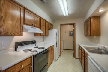 Gretna apartment for rent - A kitchen with wooden cabinets and a black stove top.