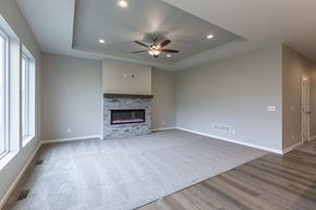 Gretna apartment for rent - A spacious living room with a fireplace and a ceiling fan.
