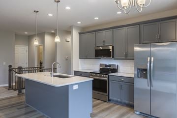 Gretna apartment for rent - A modern kitchen with a large island and stainless steel appliances.