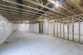 Gretna apartment for rent - A sparsely furnished room with wooden beams on the ceiling.