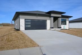 Papillion apartment for rent - A modern house with a grey and white exterior and a black roof.