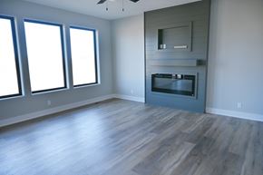 Papillion apartment for rent - A modern living room with a fireplace and wood flooring.