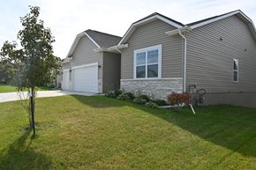 Gretna apartment for rent - A house with a grey roof and a white garage door.