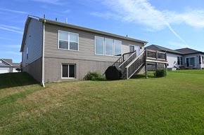 Gretna apartment for rent - A house with a grey siding and a black staircase.