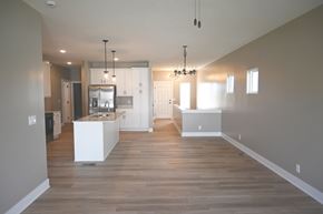 Omaha townhouse for rent - A modern kitchen with a white island and wooden floors.